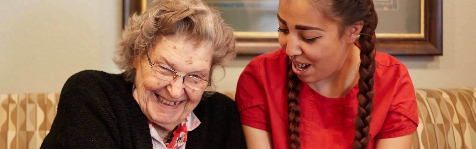 teenager helping elderly woman