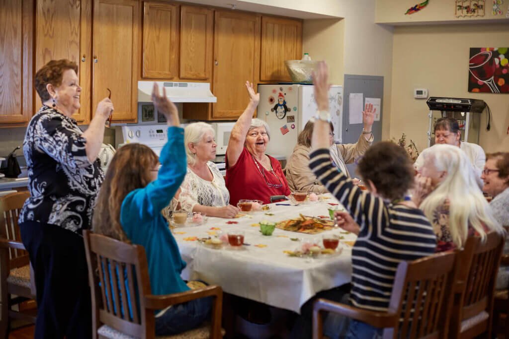 Group of seniors happily having a meal together