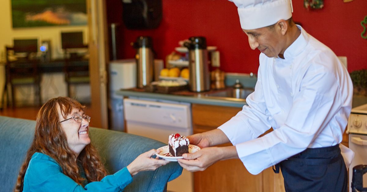 Senior Living Resident receiving restaurant style meals from a chef